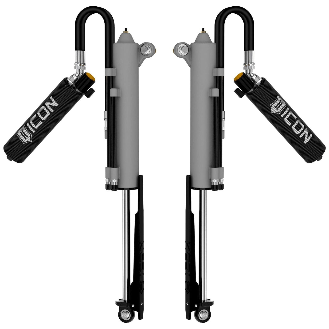 Two ICON shock absorbers on a white background